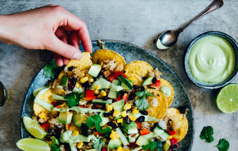 A plate filled with nachos and vegetables.